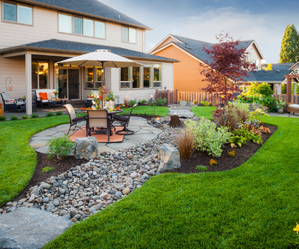 A beautifully landscaped backyard with complimenting hardscaping