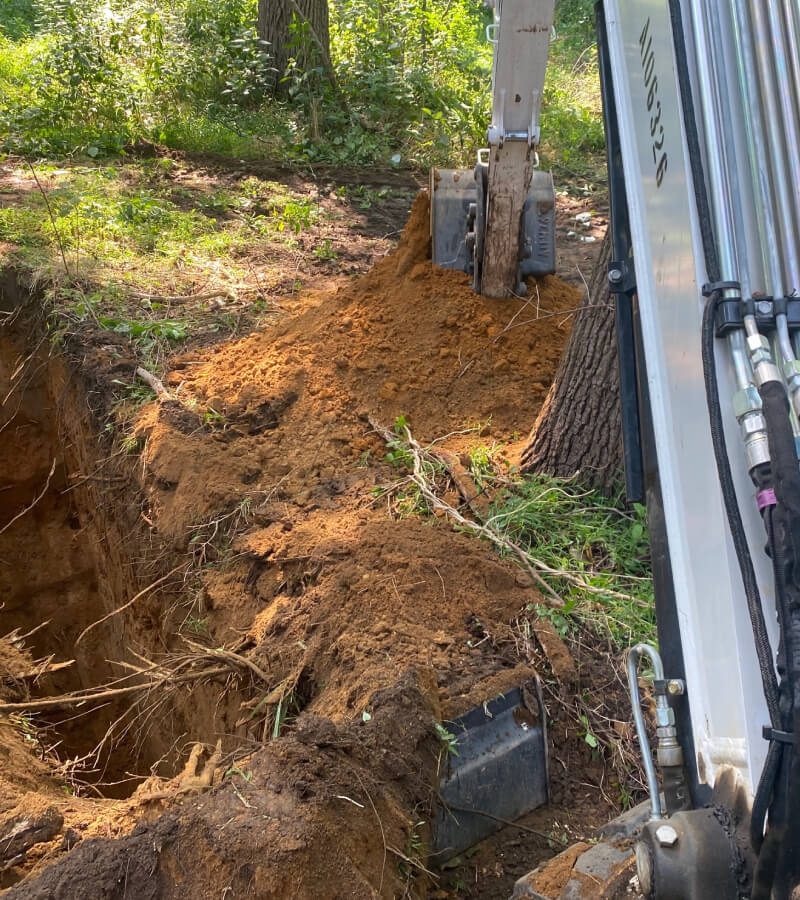 A excavator digging for geotechnical investigations