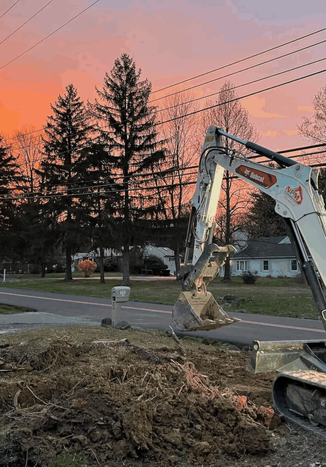 An excavator at sunset on a construction site